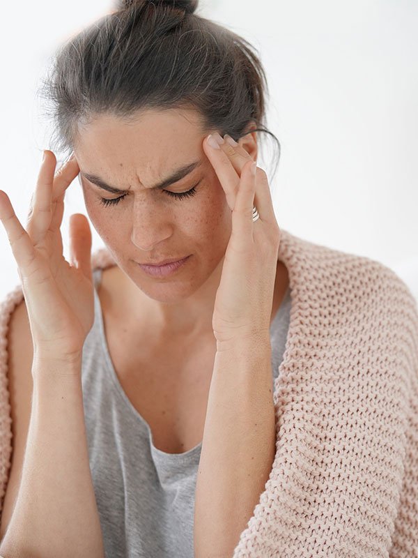 woman-with-migraine-after-work having a migraine after work and need to find a way to make it better